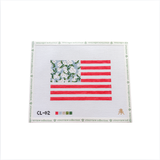 A needlepoint canvas featuring an American flag design with a floral pattern in the canton and red and white stripes, shown on a white background with a branded border.